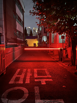 Red-lit urban corridor at night